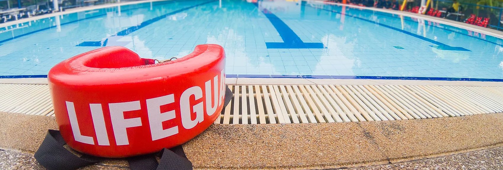 Photo of a lifeguard flotation device by the pool.