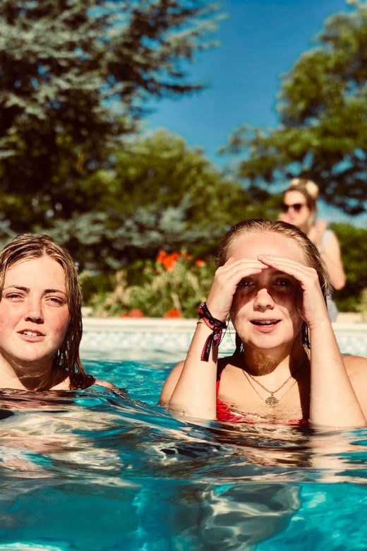 Photo of teenagers relaxing in the pool during the summer.