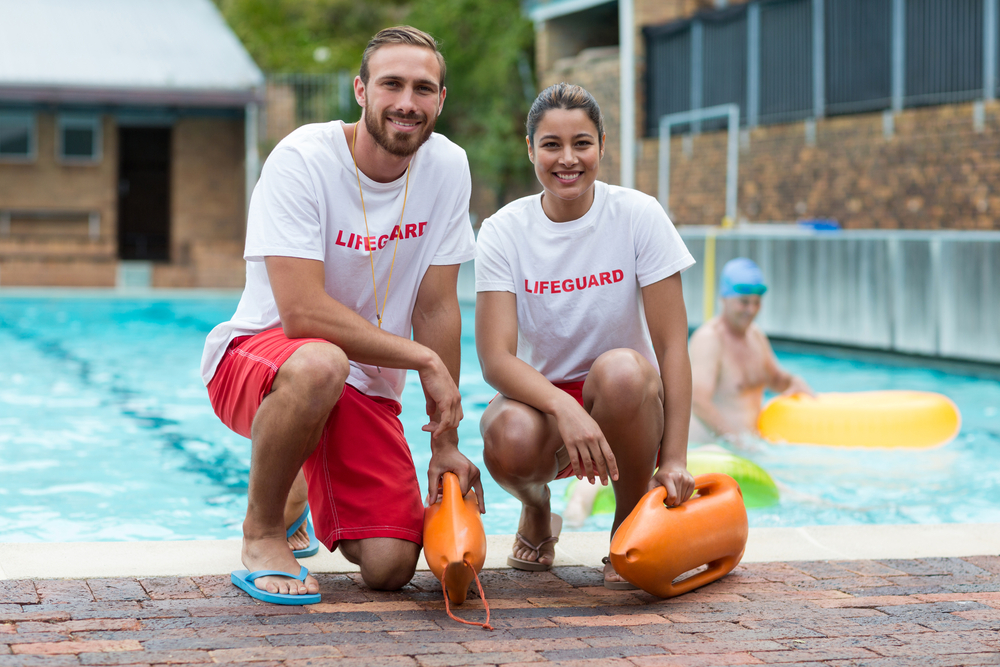 Photo of 2 lifeguards by the pool.
